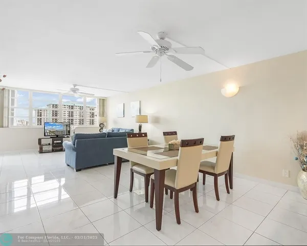 a living room with stainless steel appliances kitchen island granite countertop furniture and a kitchen view