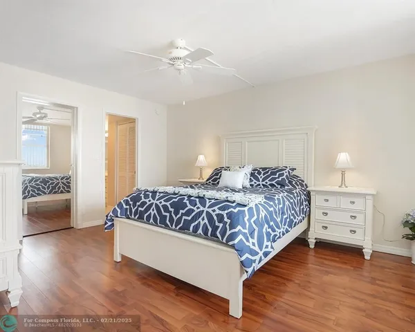 a bedroom with a large bed and a dresser