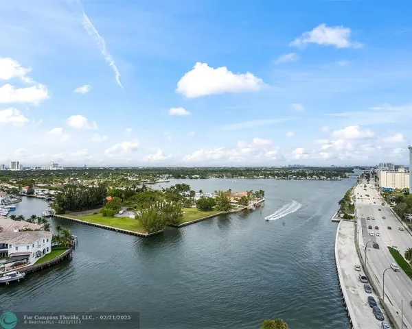 an aerial view of a house with a ocean view