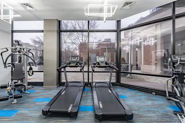333 State Street, Unit 703 Bridgeport, CT 06604 - Photo 25 of 27 a room with gym equipment and a large window
