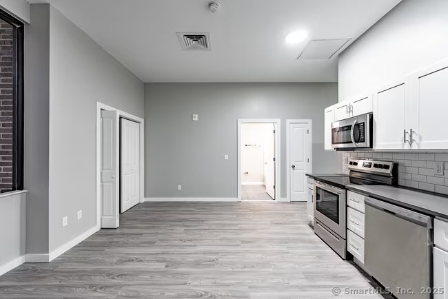 333 State Street, Unit 703 Bridgeport, CT 06604 - Photo 4 of 27 a view of a kitchen with electric appliances