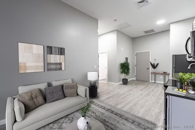 333 State Street, Unit 703 Bridgeport, CT 06604 - Photo 10 of 27 a living room with furniture and wooden floor