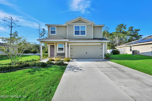 a front view of a house with a yard and garage