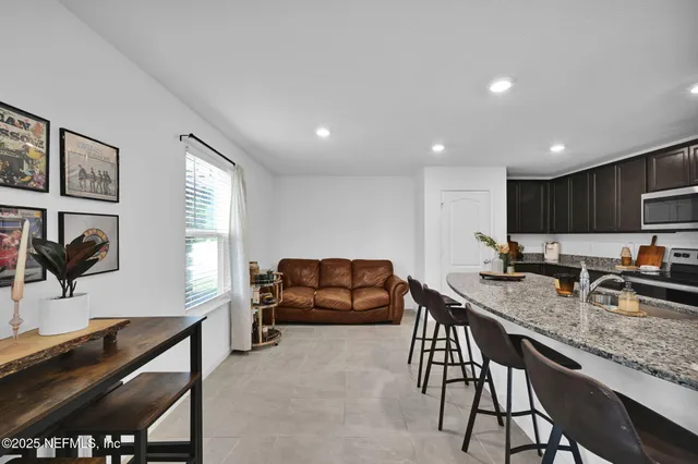 a view of kitchen with granite countertop lots of counter top space and furniture
