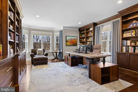a large kitchen with white cabinets and stainless steel appliances