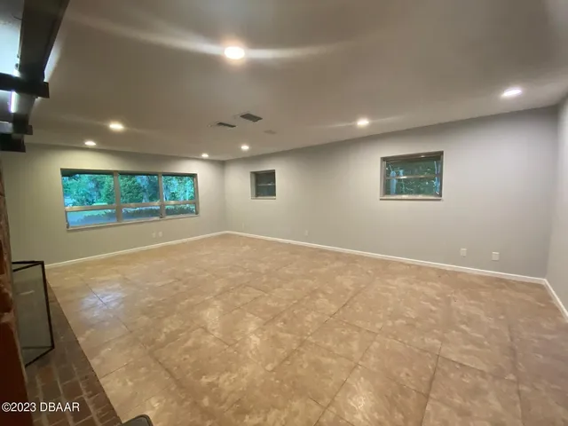 a view of an empty room with a fireplace