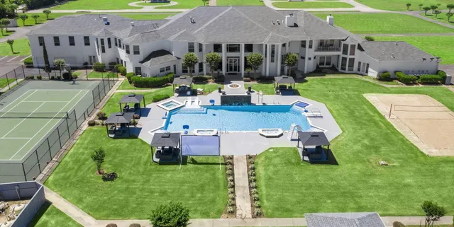 an aerial view of a house with swimming pool garden and patio