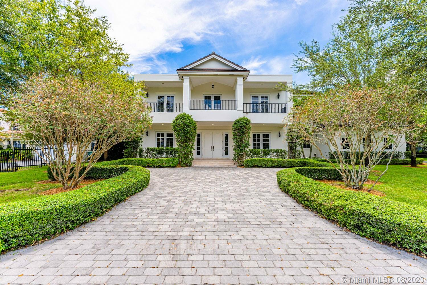 7260 Southwest 119th Street Pinecrest, FL 33156 - Photo 1 of 40 a front view of a house with a yard
