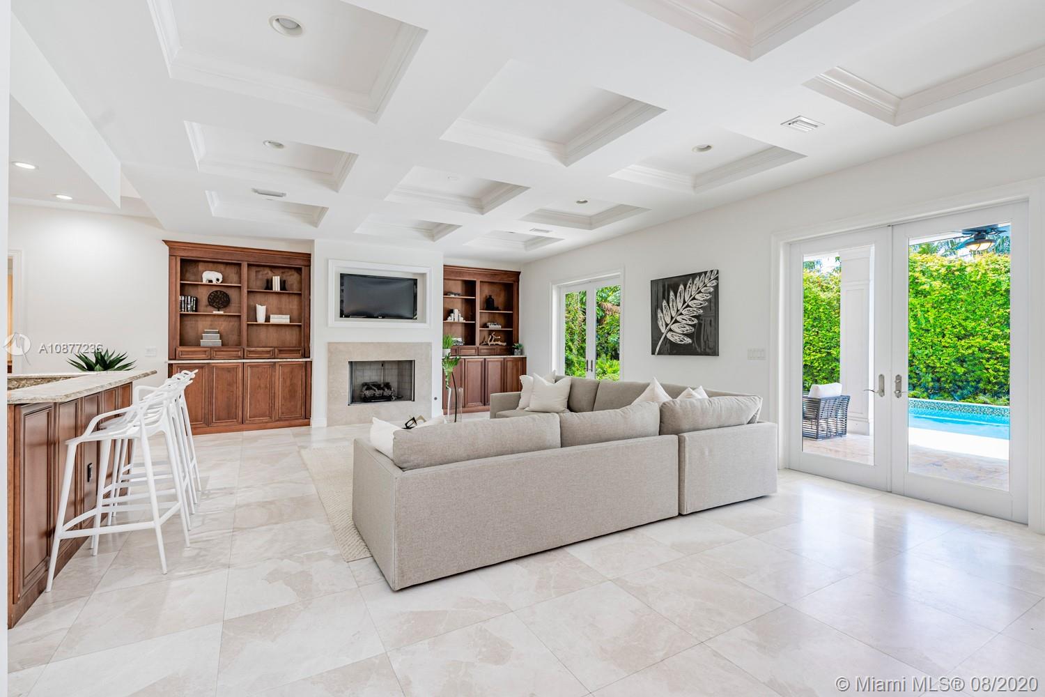7260 Southwest 119th Street Pinecrest, FL 33156 - Photo 11 of 40 a living room with furniture large window and a fireplace