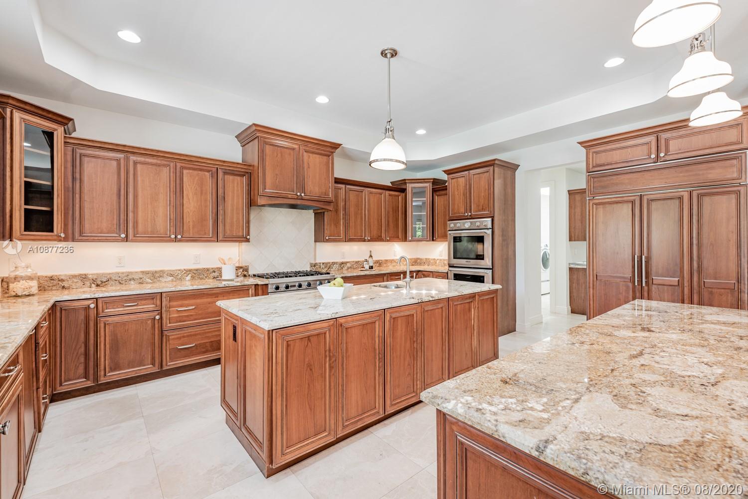 7260 Southwest 119th Street Pinecrest, FL 33156 - Photo 14 of 40 a kitchen with stainless steel appliances granite countertop wooden cabinets and a stove