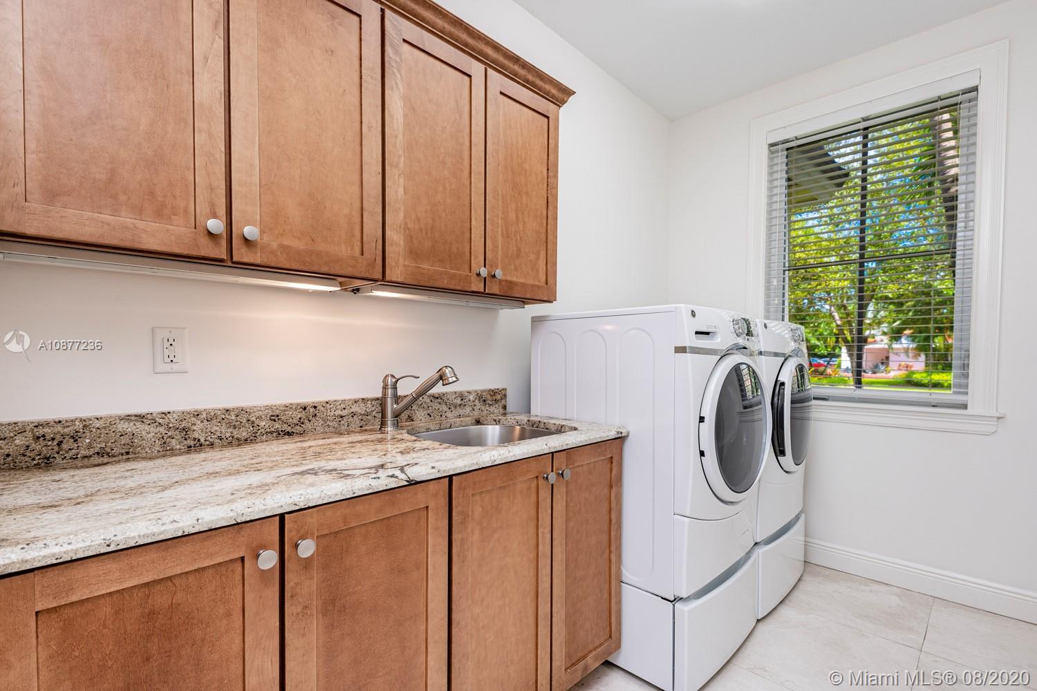 7260 Southwest 119th Street Pinecrest, FL 33156 - Photo 17 of 40 a utility room with sink dryer and washer