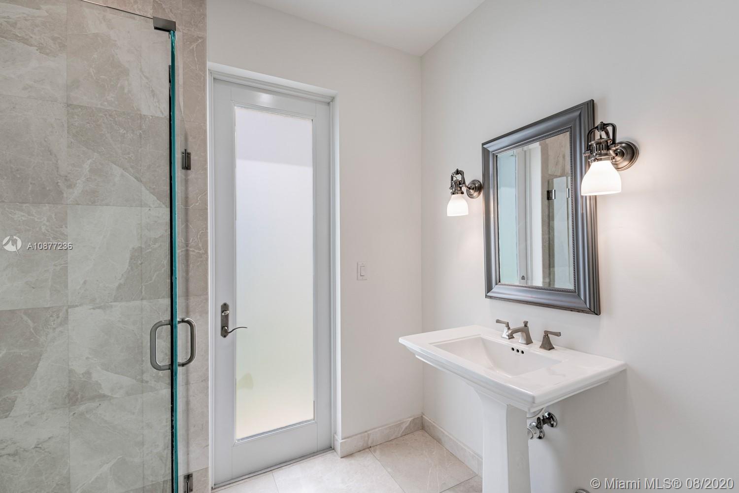 7260 Southwest 119th Street Pinecrest, FL 33156 - Photo 20 of 40 a bathroom with a sink a mirror and shower