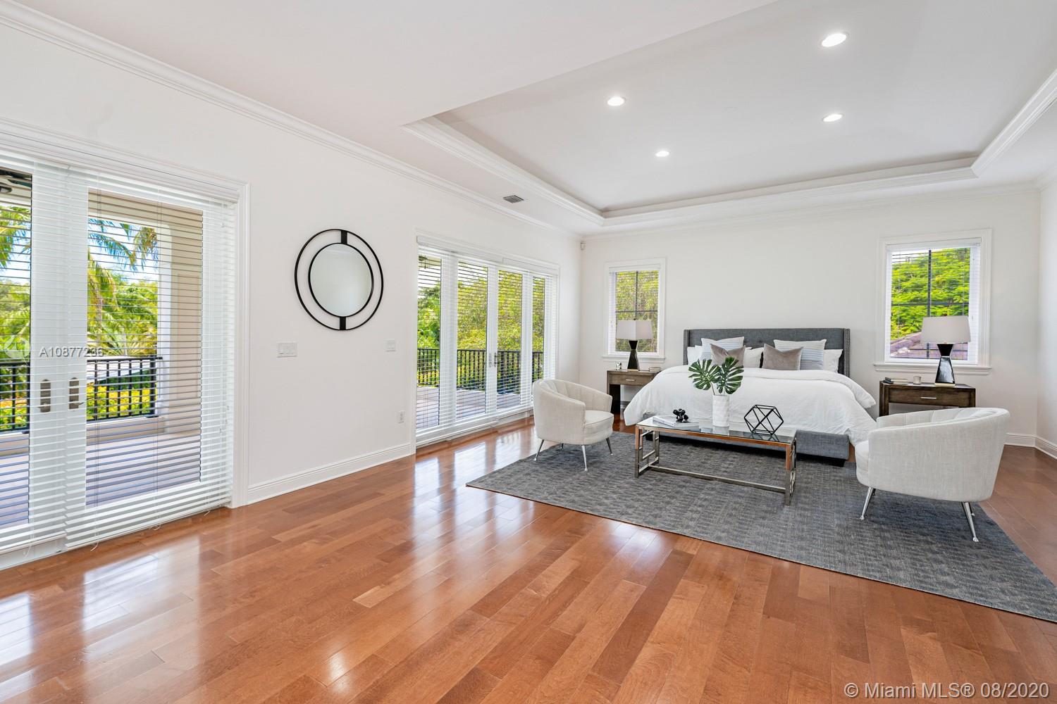 7260 Southwest 119th Street Pinecrest, FL 33156 - Photo 22 of 40 a bedroom with a bed and a large window