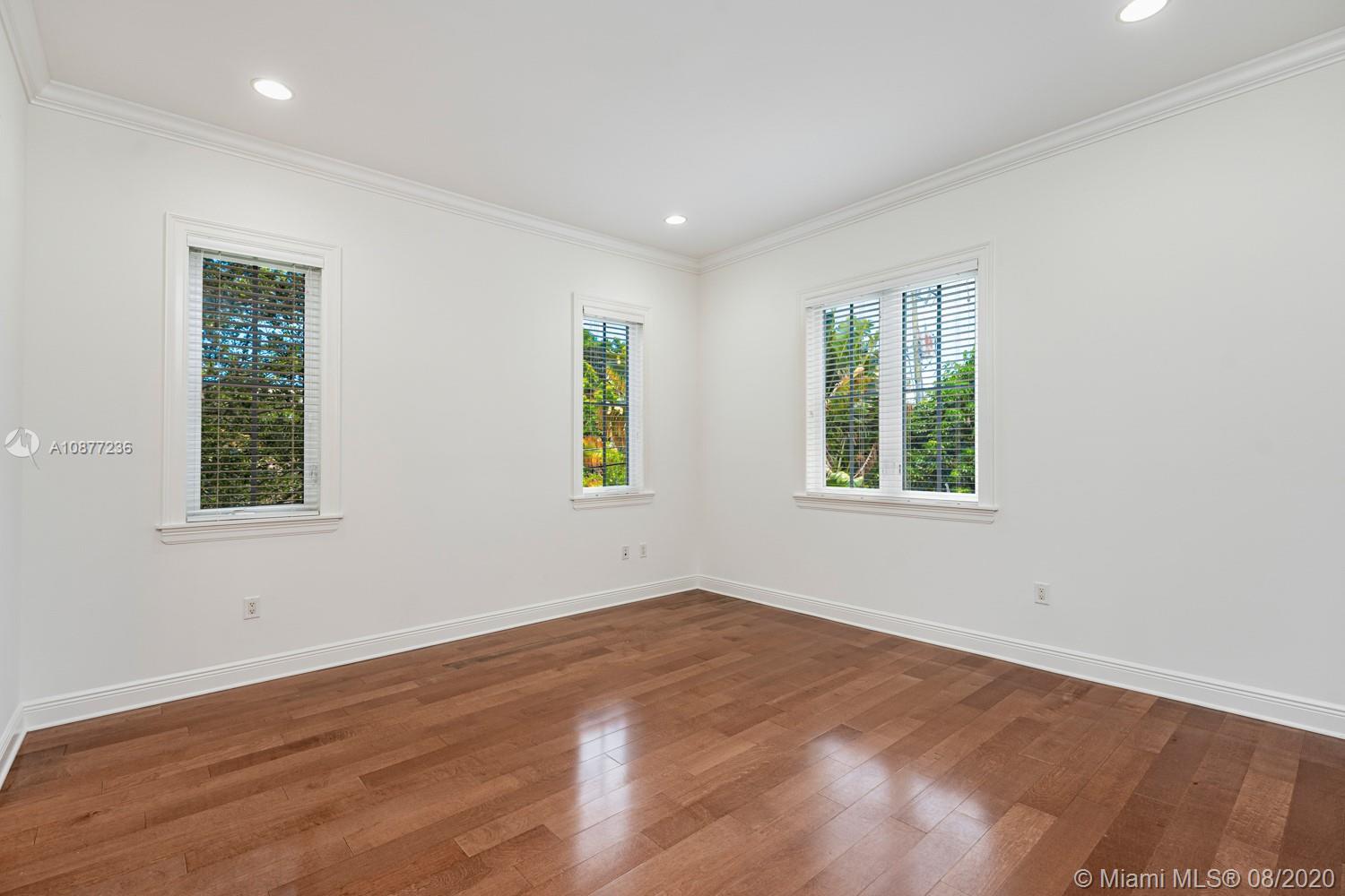 7260 Southwest 119th Street Pinecrest, FL 33156 - Photo 28 of 40 a view of an empty room with a window and wooden floor