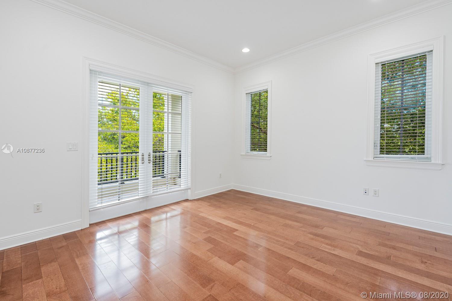 7260 Southwest 119th Street Pinecrest, FL 33156 - Photo 30 of 40 a view of an empty room with wooden floor and a window