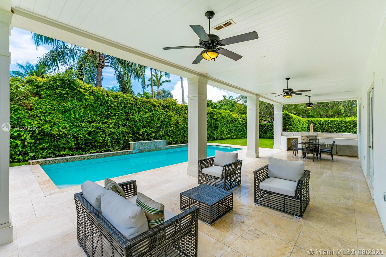 7260 Southwest 119th Street Pinecrest, FL 33156 - Photo 33 of 40 a living room with patio furniture and a garden