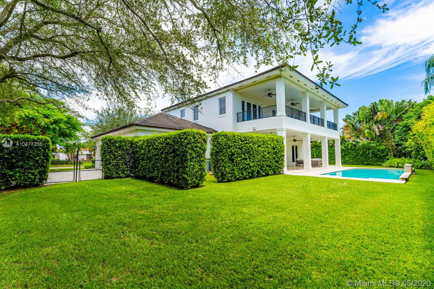 7260 Southwest 119th Street Pinecrest, FL 33156 - Photo 34 of 40 a front view of a house with a yard