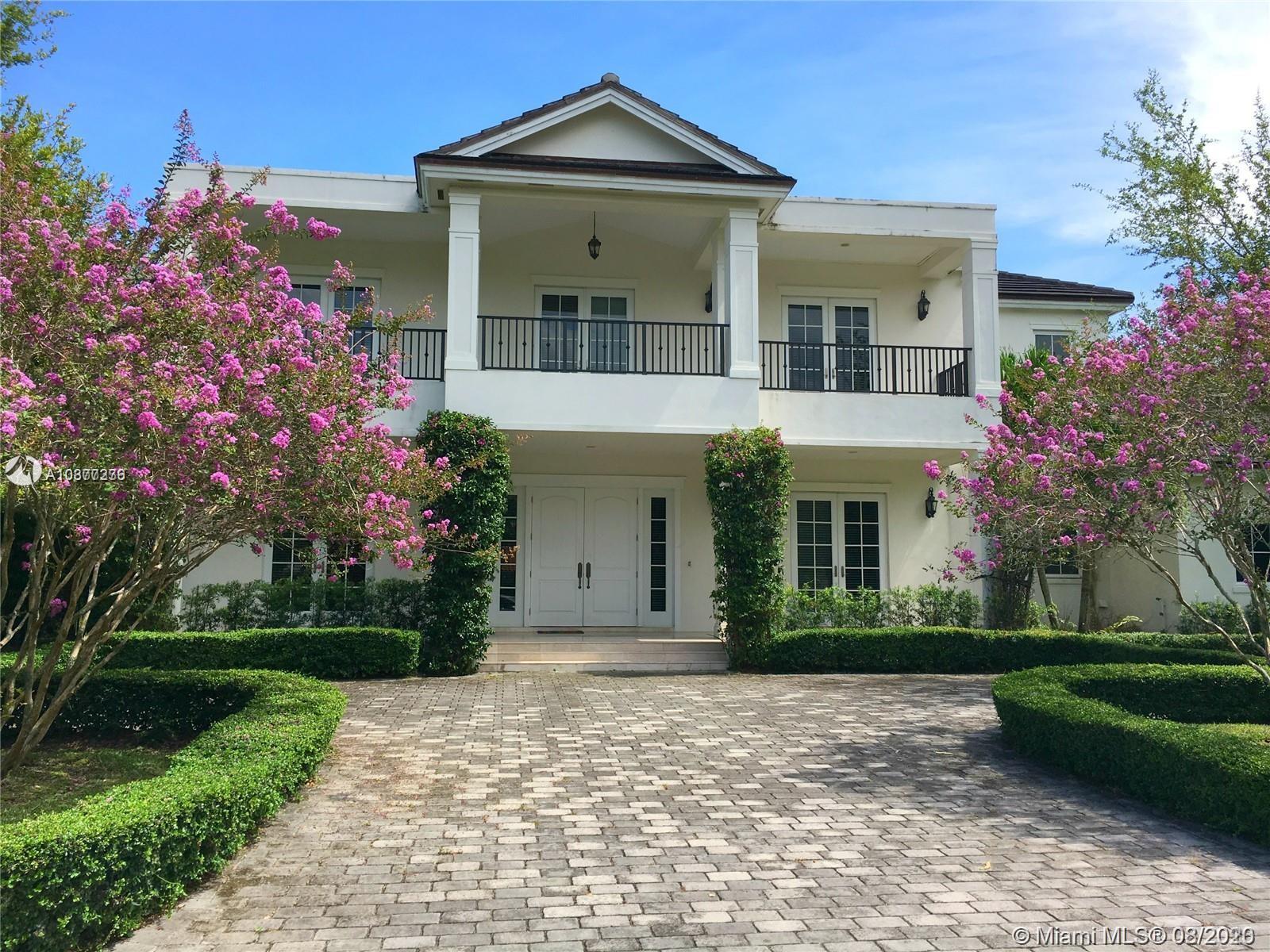 7260 Southwest 119th Street Pinecrest, FL 33156 - Photo 40 of 40 a front view of a house with garden
