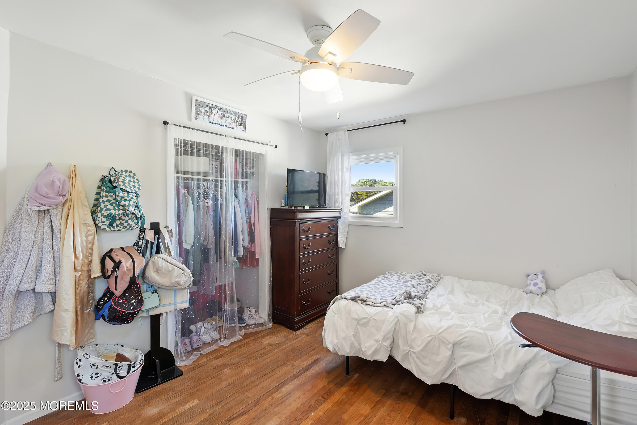 10 Marion Avenue Howell, NJ 07731 - Photo 11 of 26 a bedroom with a bed and a chandelier