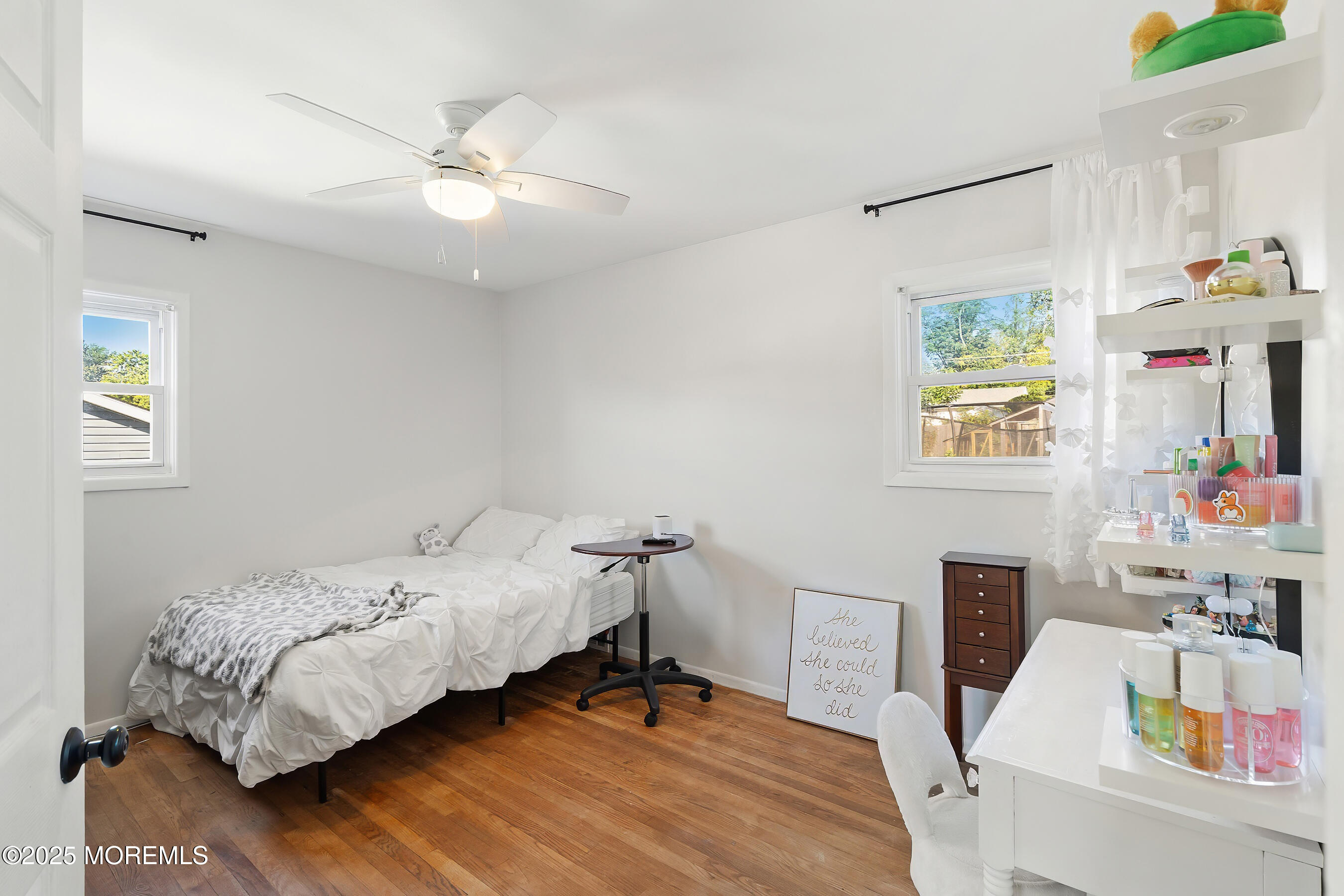 10 Marion Avenue Howell, NJ 07731 - Photo 10 of 26 a bedroom with a bed and a chandelier