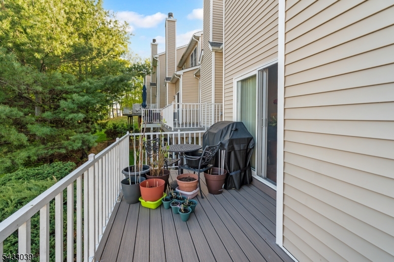 158 Autumn Ridge Road Morris Plains, NJ 07950 - Photo 16 of 26 a view of a balcony with chairs and wooden floor