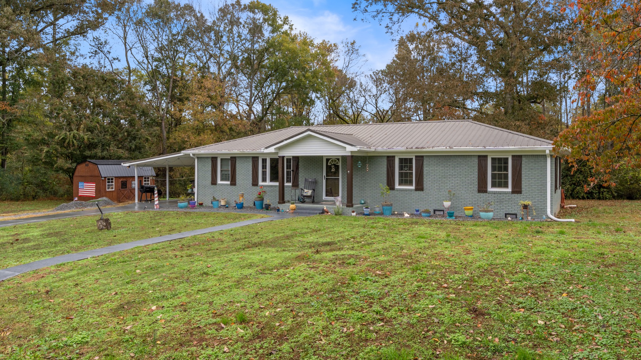 a front view of a house with a garden