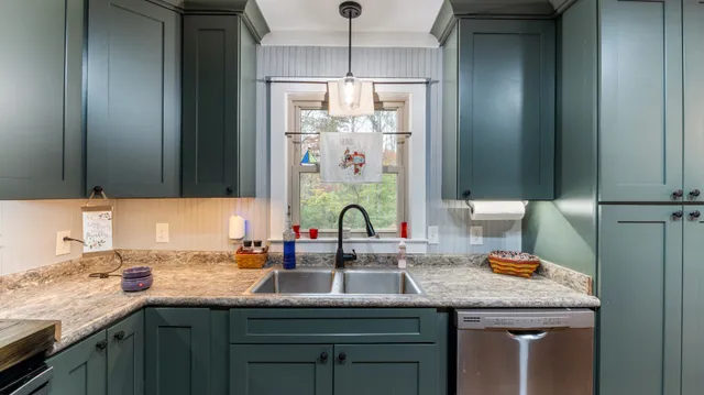 a kitchen with a sink and a window