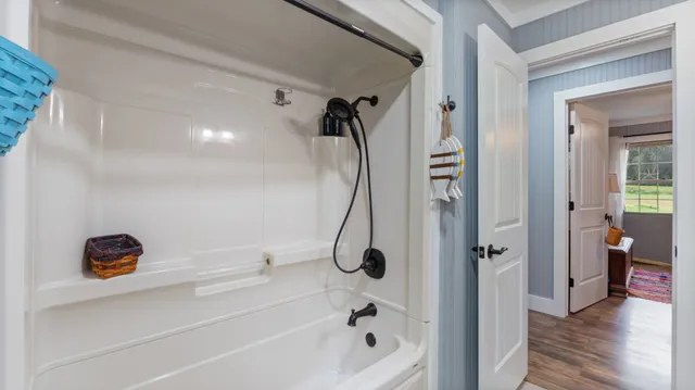 a bathroom with a tub and a shower