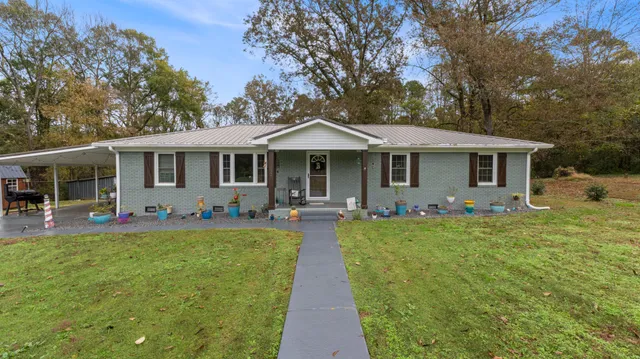 a front view of a house with swimming pool having outdoor seating