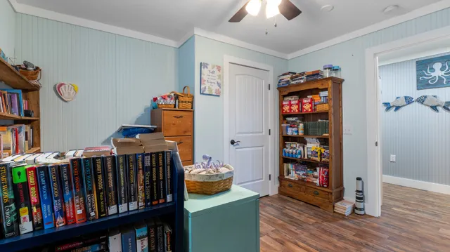 a bedroom with furniture and a book shelf