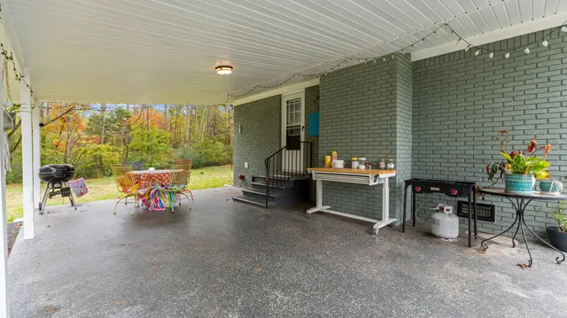 a view of a patio with table and chairs and potted plants
