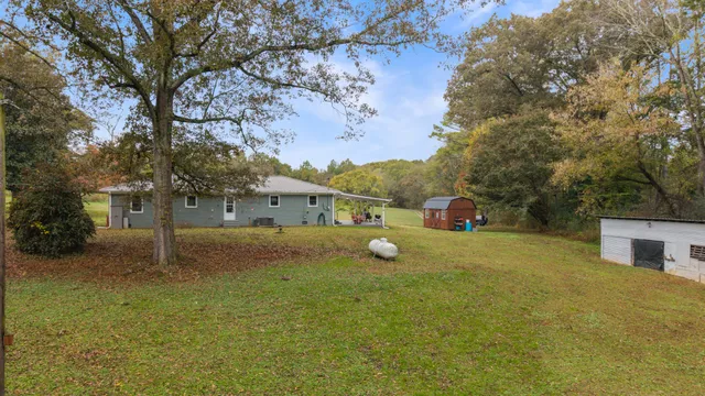 a view of a house with a backyard