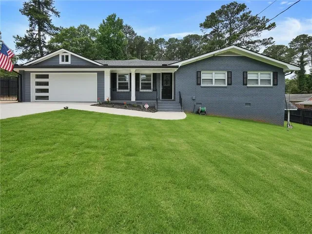 a front view of house with yard and green space