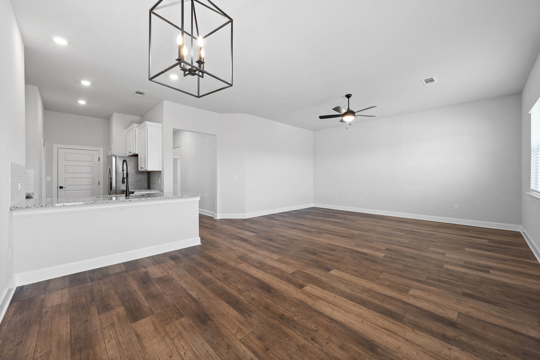 9617 Gladsome Path Manor, TX 78653 - Photo 4 of 16 a view of a kitchen with sink and wooden floor