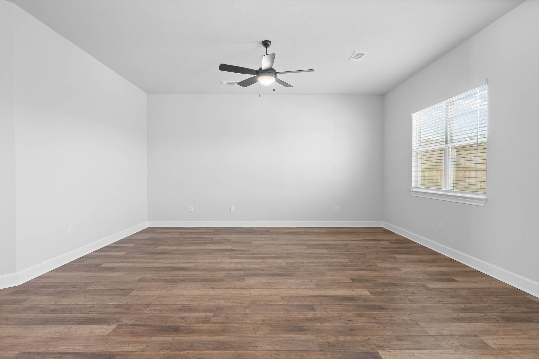 9617 Gladsome Path Manor, TX 78653 - Photo 5 of 16 wooden floor in an empty room with a window
