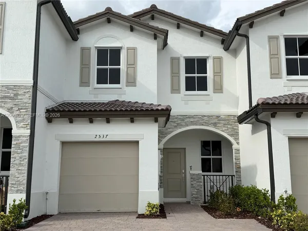 a front view of a house with garage