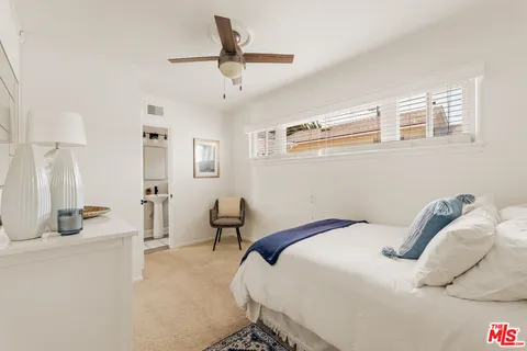 a bedroom that has a bed and a chandelier