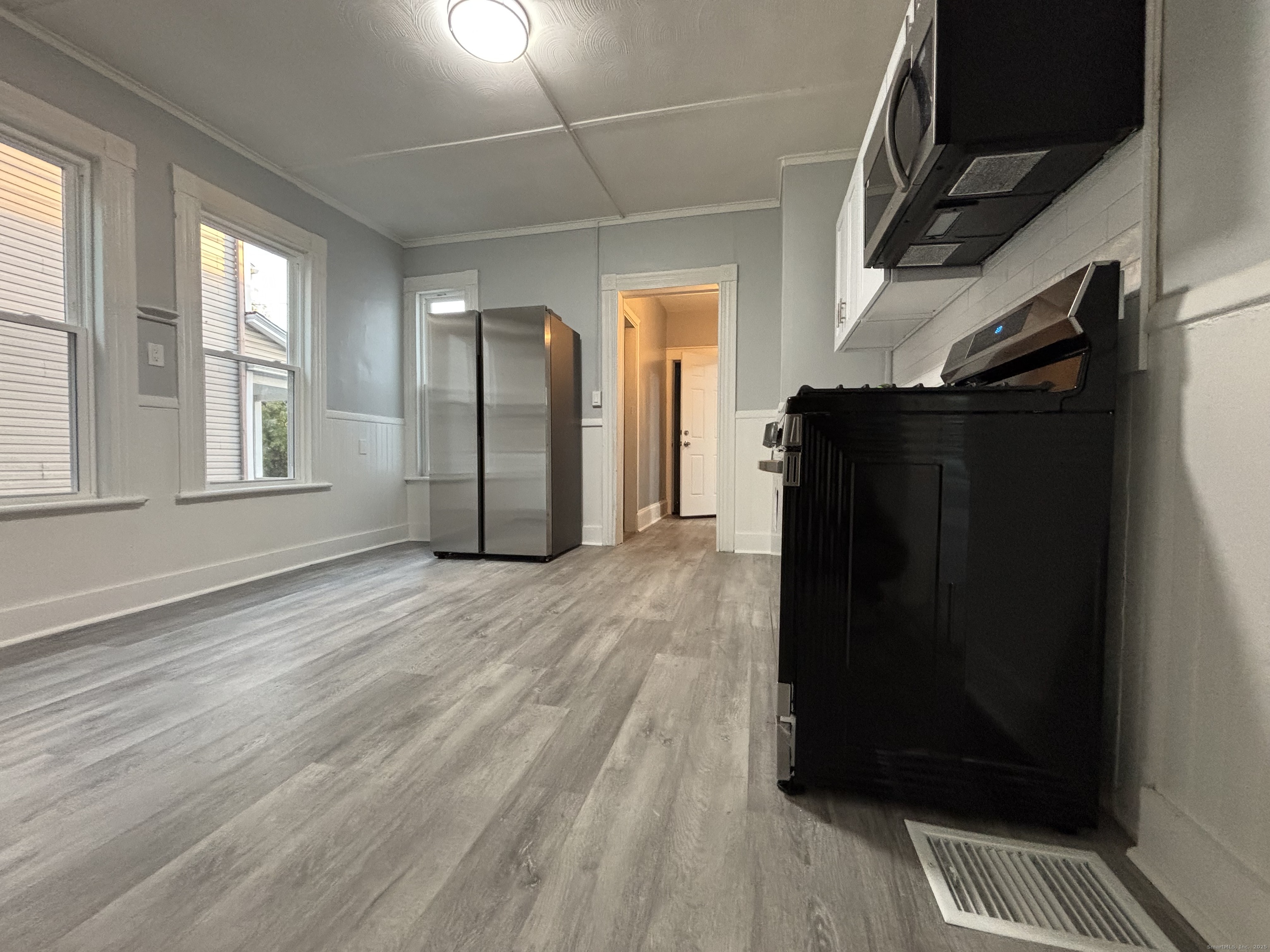 Undisclosed Address Bridgeport, CT 06605 - Photo 15 of 18 a view of empty room with wooden floor and fan