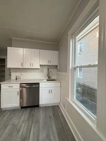 a kitchen with a white stove top oven and sink