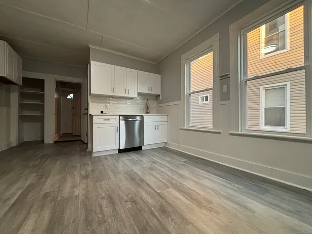 a view of a kitchen with a sink cabinets and a window