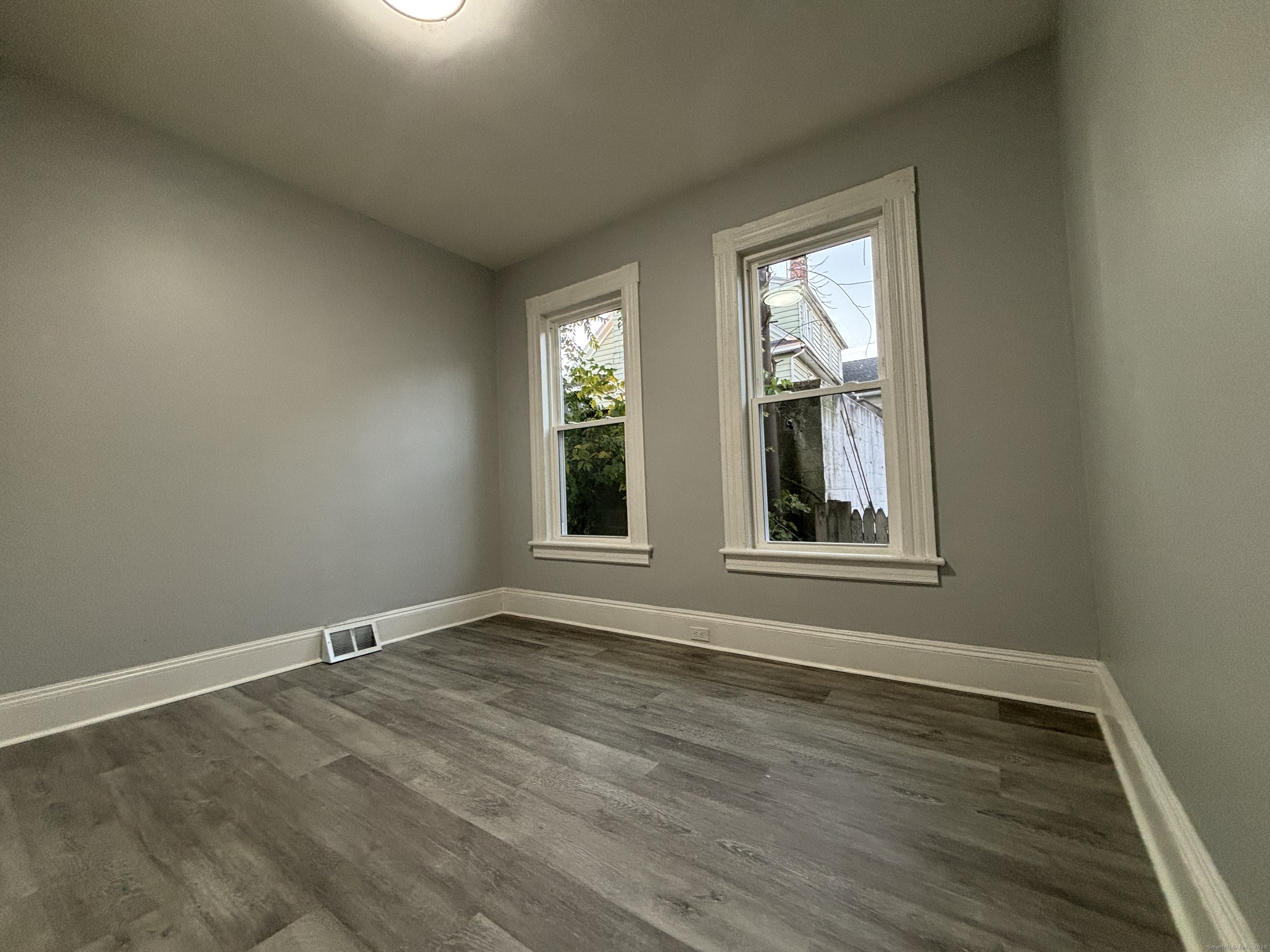 Undisclosed Address Bridgeport, CT 06605 - Photo 8 of 18 a view of an empty room with wooden floor and a window
