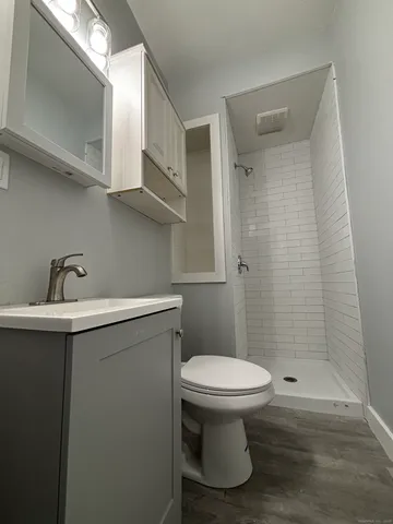 a bathroom with a sink toilet and shower
