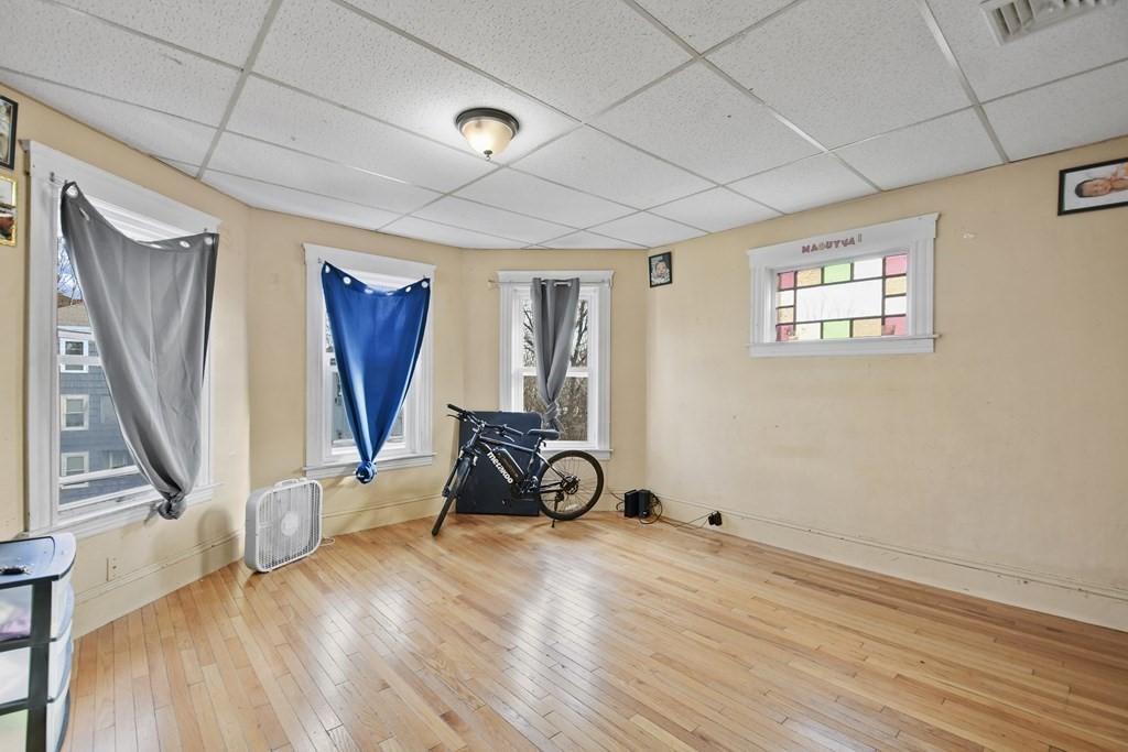 52 Crystal Street Worcester, MA 01603 - Photo 14 of 29 a view of an empty room with wooden floor and a window
