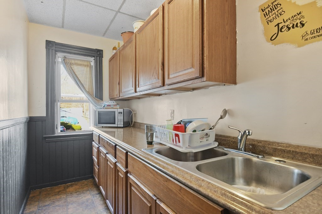 52 Crystal Street Worcester, MA 01603 - Photo 18 of 29 a kitchen with a sink cabinets and window