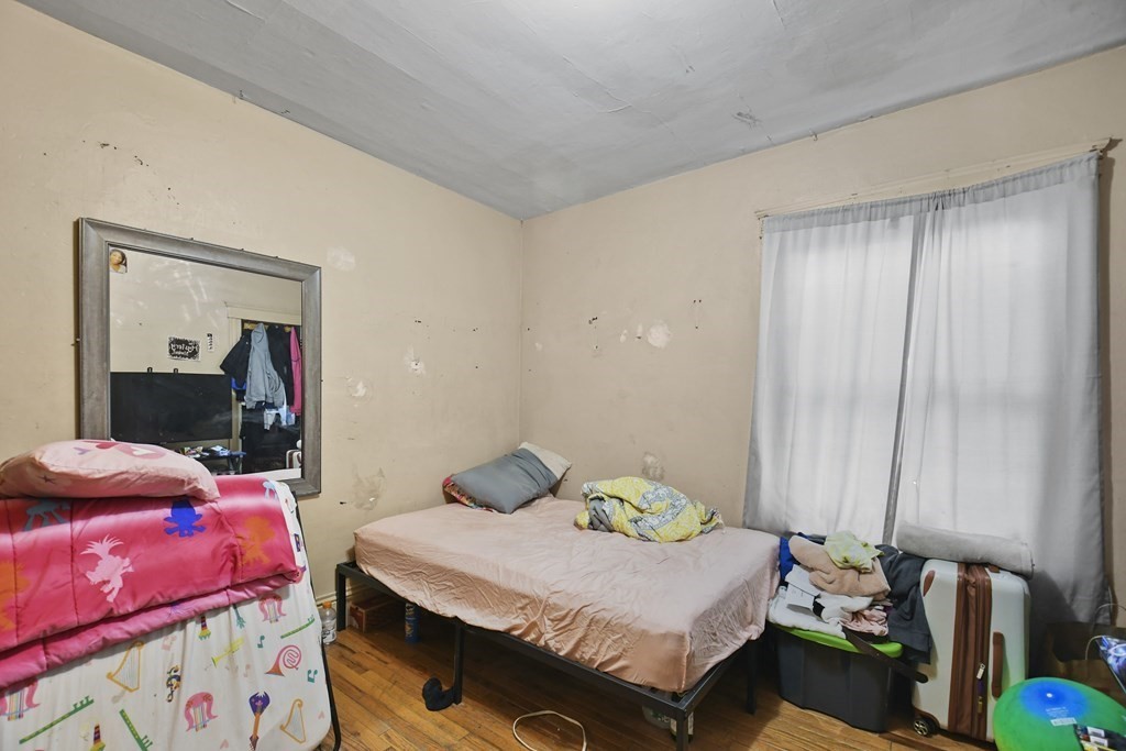 52 Crystal Street Worcester, MA 01603 - Photo 24 of 29 a bedroom with a bed and a mirror