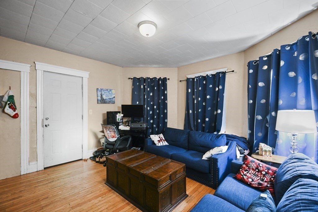 52 Crystal Street Worcester, MA 01603 - Photo 3 of 29 a living room with furniture and wooden floor