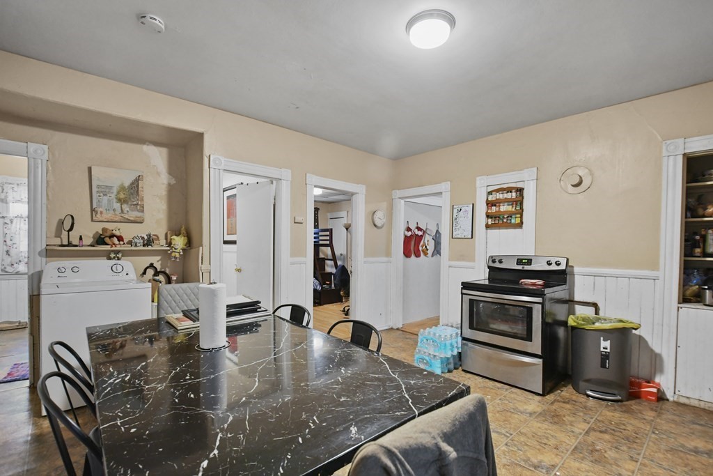 52 Crystal Street Worcester, MA 01603 - Photo 7 of 29 a kitchen with stainless steel appliances granite countertop a stove top oven a sink dishwasher and a refrigerator with wooden floor
