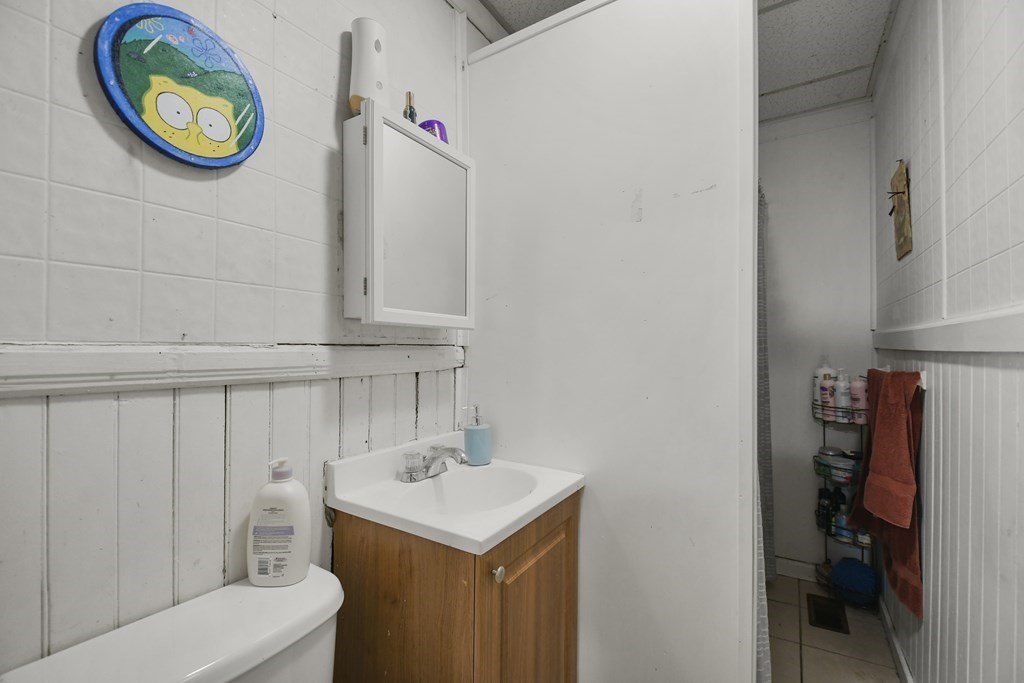 52 Crystal Street Worcester, MA 01603 - Photo 10 of 29 a bathroom with a sink a toilet and a mirror