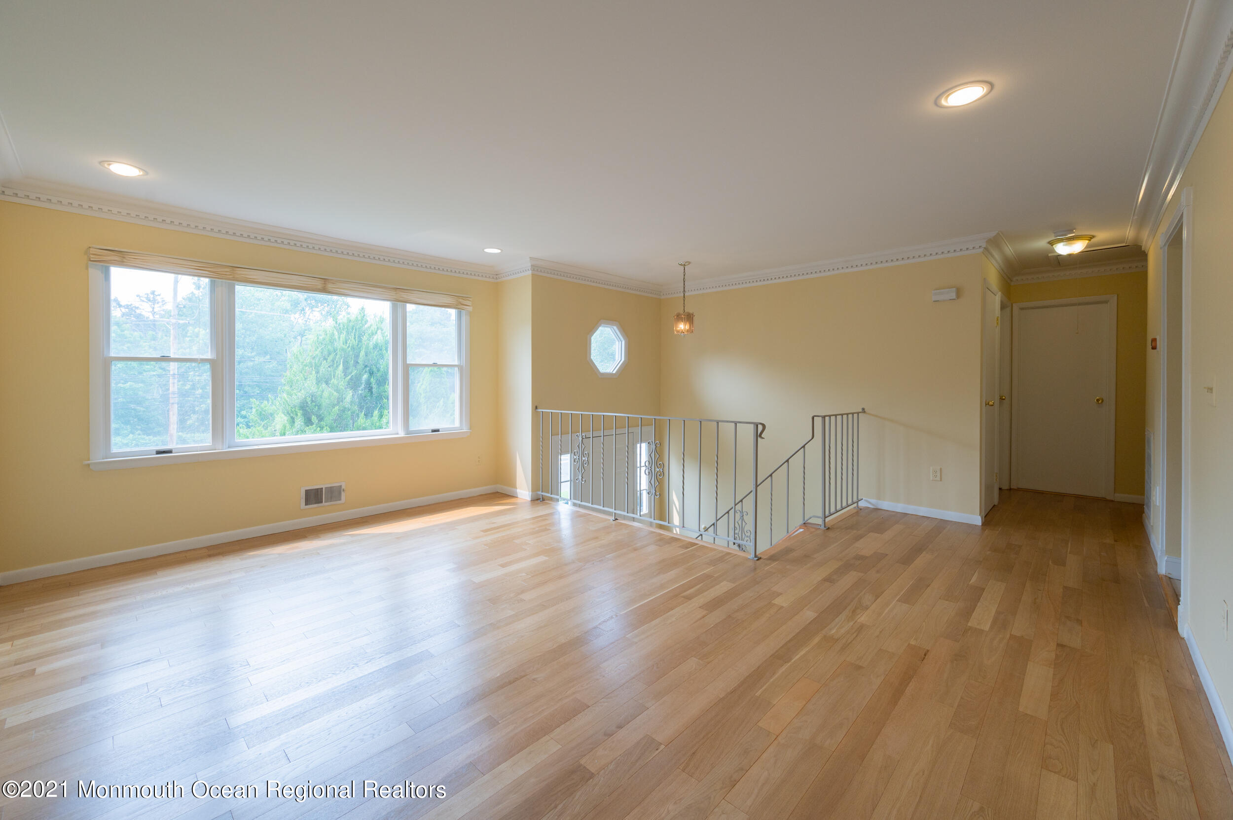 2816 Shafto Road Tinton Falls, NJ 07753 - Photo 11 of 24 a view of an empty room with wooden floor and a window