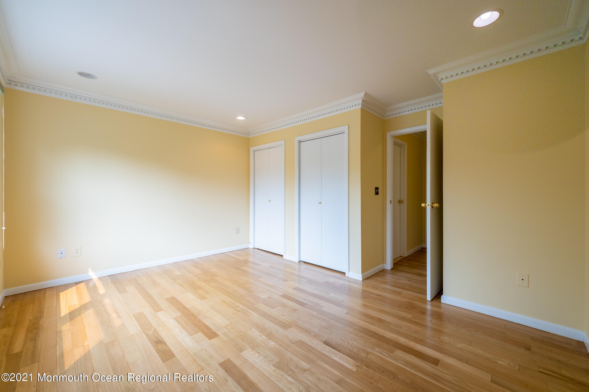 2816 Shafto Road Tinton Falls, NJ 07753 - Photo 16 of 24 a view of an empty room with wooden floor and a window